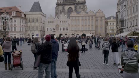 Busy-Prague-street-with-a-view-of-the-Gothic-Tyn-Church-and-tourists-enjoying-the-day
