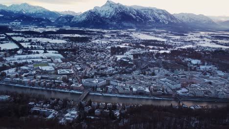 Salzburg-aerial-view-of-old-town-with-castle-and-river-Salzach,-snow-covered
