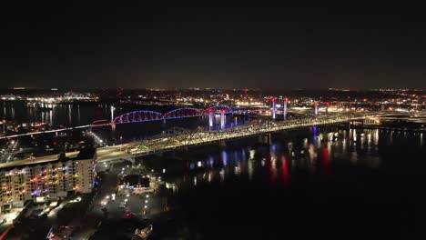 Bridges-spanning-Indiana-and-Kentucky-over-the-Ohio-River-with-drone-video-moving-forward-at-night
