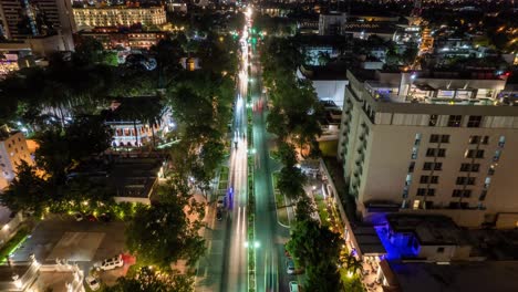 aerial-nighttime-photograph-of-a-vibrant-city-boulevard,-alive-with-the-warm-glow-of-streetlights-that-trace-a-path-through-the-urban-landscape