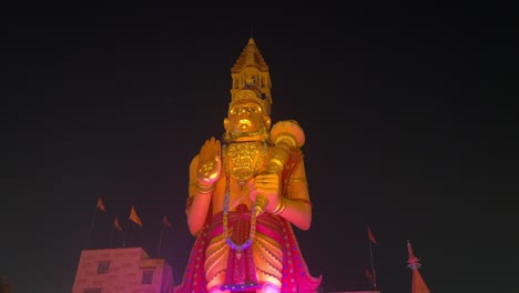 Night-view-of-biggest-golden-statue-of-Lord-Hanuman-in-front-of-temple-at-Rajarhat-in-Kolkata,-India