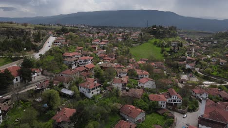 Small-houses-and-brick-chimneys-in-the-town-are-on-the-world-heritage-list,-drone-view,-Turkey