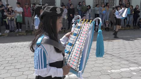 Young-girls-play-marching-xylophones-day-of-independence-street-parade-slo-mo