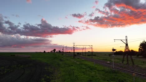 Rising-aerial-drone-shot-over-railway-tracks-in-the-farmlands-of-the-Free-State,-South-Africa
