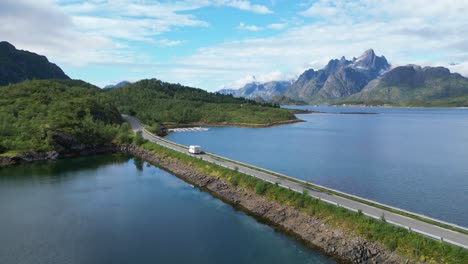 RV-Camper-drives-Fjord-bridge-in-Lofoten-Islands,-Norway---Aerial