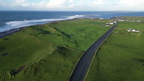 Slow-aerial-establishing-shot-of-houses-with-a-view-over-the-Doolin-cliffs
