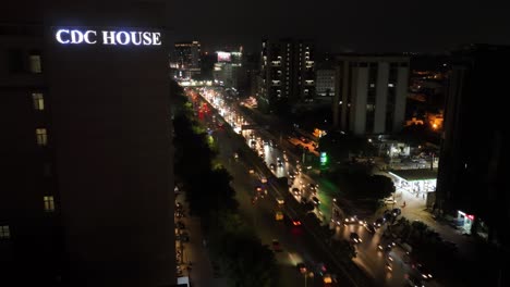 Timelapse-drone-shot-of-Nursery-Flyover-and-Shahrah-e-Faisal-Road-near-CDC-House-during-a-busy-night-in-Karachi,-Pakistan