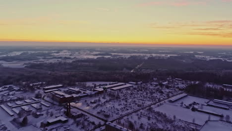 Sunset-over-a-district-heating-plant---pullback-aerial-reveal