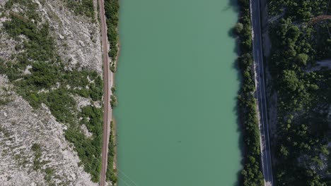 View-from-above-of-the-Neretva-River-in-the-Bosnian-city,-the-river-passing-through-the-canyon