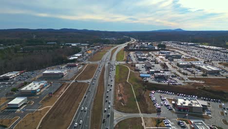 Slow-traffic-on-american-highway-near-Atlanta-City-with-hills-in-background-during-sunny-day---Aerial-wide-shot