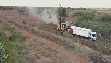 Providing-fresh-water-to-African-villages-by-drilling-borehole-well-in-Kenya,-aerial-view