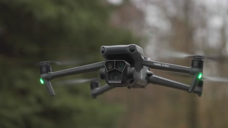 Drone-hover-and-stay-steady-in-windy-environment-with-blurry-forest-background