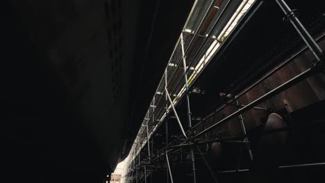 looking-up-at-a-scaffold-system-that-goes-around-the-exterior-of-an-old-ship