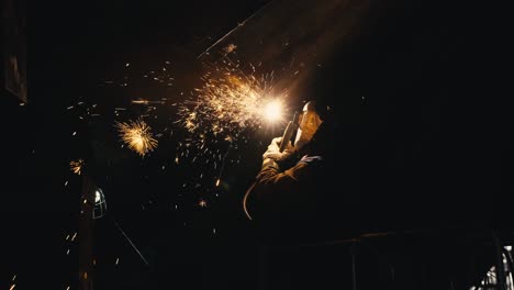 medium-tight-shot-of-a-man-welding-metal-together-on-an-old-ship-with-sparks-flying-everywhere