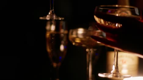 Pouring-champagne-into-glasses-at-a-celebration-party-in-4K