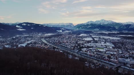 Snow-covered-Austria-city-of-Salzburg-with-view-of-Mountain-Alps,-aerial