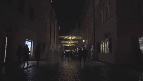 People-Walk-in-Poland,-Winter-Night-at-Old-town-Warsaw-Street