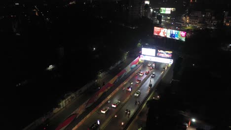 Rajkot-aerial-drone-view,-Lots-of-vehicles-passing-and-going-through-Under-bridge