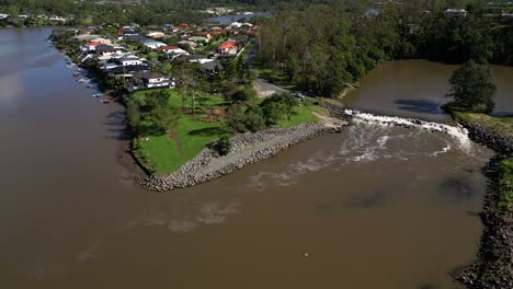 Oxenford,-Gold-Coast,-4-January-2024---Circular-aerial-views-of-the-Coomera-River-and-Causeway-with-receding-flood-waters-from-the-January-storms