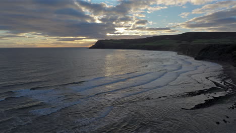 Establishing-Drone-Shot-of-Yorkshire-East-Coast-Beach-and-Cliffs-Sunrise