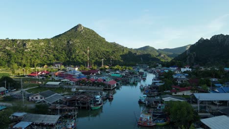 Drone-slides-to-the-left-revealing-this-picturesque-fishing-village,-Bang-Pu-Fishing-Village,-Sam-Roi-Yot-National-Park,-Prachuap-Khiri-Khan,-Thailand