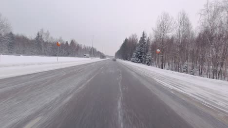 Winter-conditions-on-the-highway-don't-hinder-the-car,-which-expertly-speeds-through-snowy-terrain