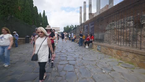 Rome-Immersive-POV:-Moving-In-Busy-Streets-to-Chiesa-Santi-Luca-e-Martina,-Italy,-Europe,-Walking,-Shaky,-4K-|-Woman-Walking-Amongst-Crowds-Near-Historic-Ruins