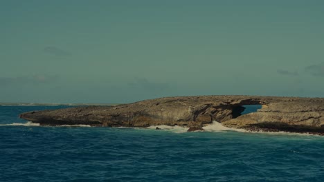 deep-blue-ocean-waves-from-the-Pacific-crash-against-this-rocky-peninsula-with-a-natural-stone-bridge-in-East-Point-Honolulu-Hawaii