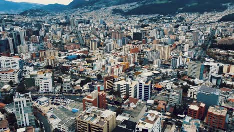Drone-pan-shot-from-the-air-over-the-city-center-of-Quito,-Ecuador