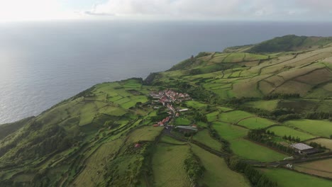 Vista-Aérea-De-La-Pequeña-Ciudad-De-Mosteiro-En-Un-Paisaje-Verde-En-Flores-Azores