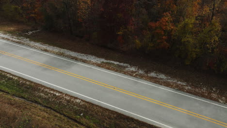 High-angle-view-of-contryside-road-in-Arkansas-surrounded-by-Autumn-fall-trees