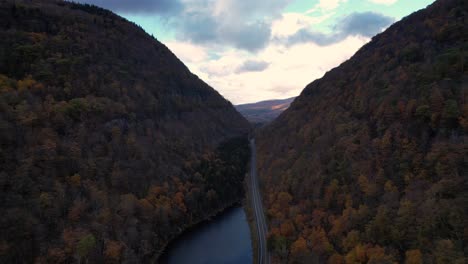 Beautiful-drone-footage-of-a-deep-autumnal-valley-with-beautiful-colors-and-mountain-road