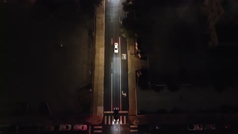 Fort-Worth,-Texas-traffic-intersection-at-night-with-drone-video-tilting-up