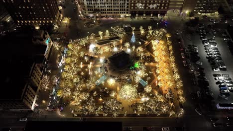Plaza-with-Christmas-lights-in-downtown-El-Paso,-Texas-at-night-with-stable-drone-video