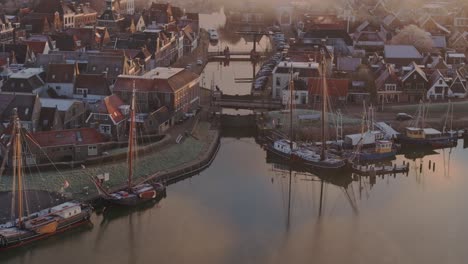 Reveal-shot-of-Makkum-Friesland-during-foggy-morning,-aerial