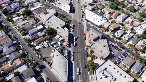 Drone-Shot-of-Mid-City,-Los-Angeles-Central-Neighborhood,-Street-Traffic-and-Buildings
