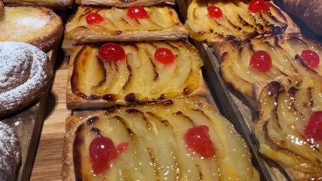 Delicious-fruit-tarts-with-glaze-and-croissants-on-a-wooden-board