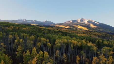 Colorful-Colorado-cinematic-aerial-drone-Kebler-Pass-Crested-Butte-Gunnison-wilderness-autumn-fall-Aspen-Trees-morning-dramatic-incredible-landscape-sunrise-first-light-on-Rocky-Peaks-forward-motion