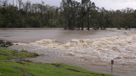 Coomera,-Gold-Coast,-2-January-2024---Medium-shot,-Coomera-River-Causeway-under-flood-waters-from-the-2024-Storms-in-January