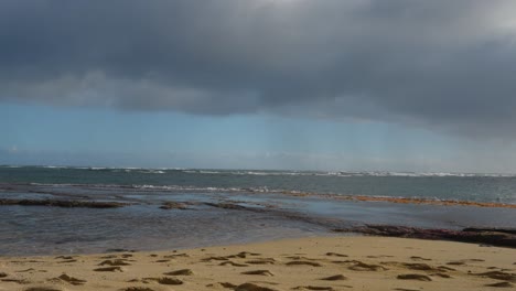 a-stormy-cloud-shelf-looms-over-the-beach-and-coastal-tide-pools-on-the-island-of-Oahu-Hawaii-near-Diamond-Head