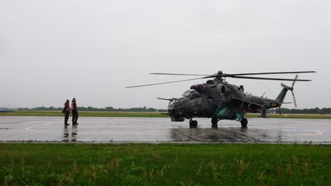 Large-gunship-helicopter-rotor-blades-spin,-prepare-take-off-maneuver