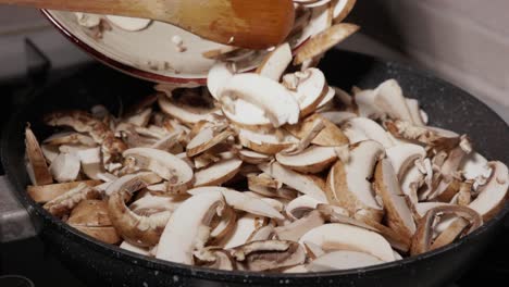 Putting-Chopped-Mushrooms-Into-Frying-Pan---Close-Up