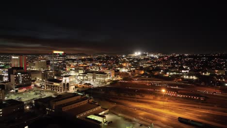El-Paso,-Texas-skyline-at-night-with-drone-video-showing-traffic-moving-left-to-right