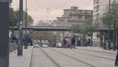 Slow-Motion-Shot-of-a-Man-Crossing-Tramway-Rails-In-Vincennes,-France
