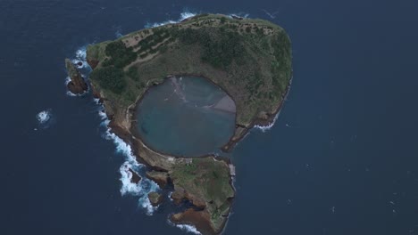 A-beautiful-small-island-in-the-middle-of-the-sea-on-a-cloudy-day-Sao-Miguel-in-Azores,-aerial