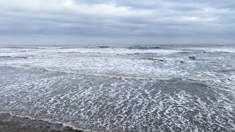 Rough-waves-thrashing-on-a-cold-beach-from-the-North-Sea-during-a-cloudy-day