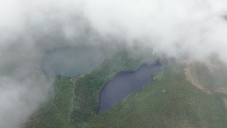 Miradouro-Lagoa-Negra-e-Lagoa-Comprida-with-low-clouds-at-Flores-azores---drone-shot