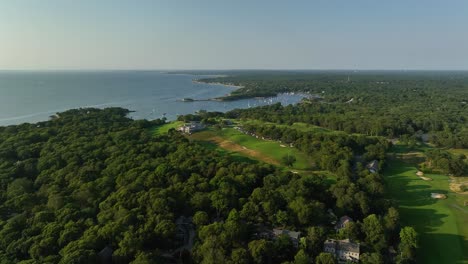Drone-shot-of-lush-forests-surrounding-a-Cape-Cod-golf-course