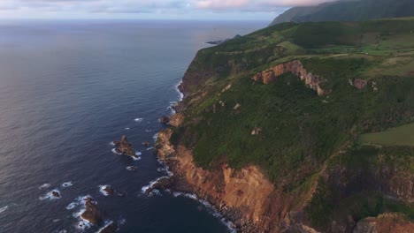 Bird-eye-view-of-rough-coastline-at-Azores-island-during-sunset,-aerial