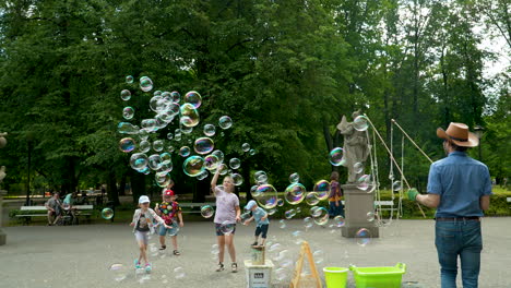 Bubble-performer-in-a-park-with-statues